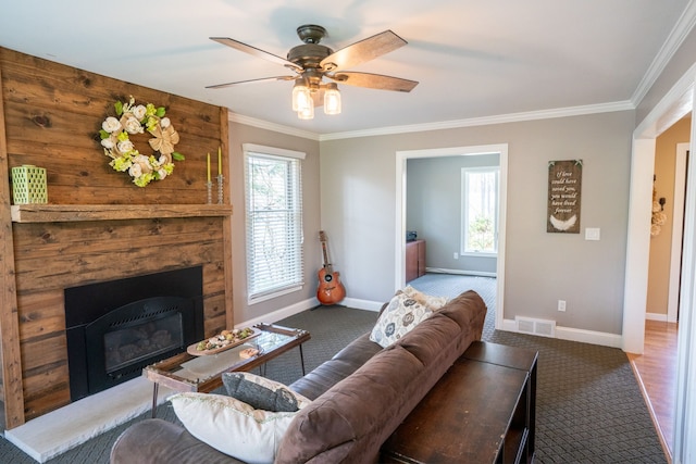 carpeted living room featuring baseboards, visible vents, and ornamental molding
