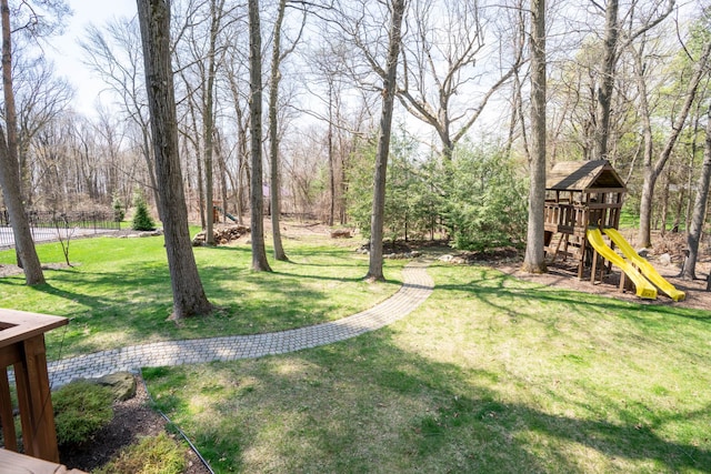view of yard featuring a playground and fence
