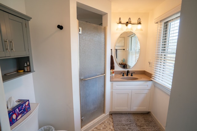 bathroom featuring toilet, a walk in shower, vanity, and baseboards