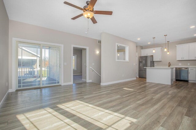 unfurnished living room featuring recessed lighting, visible vents, light wood-type flooring, baseboards, and ceiling fan