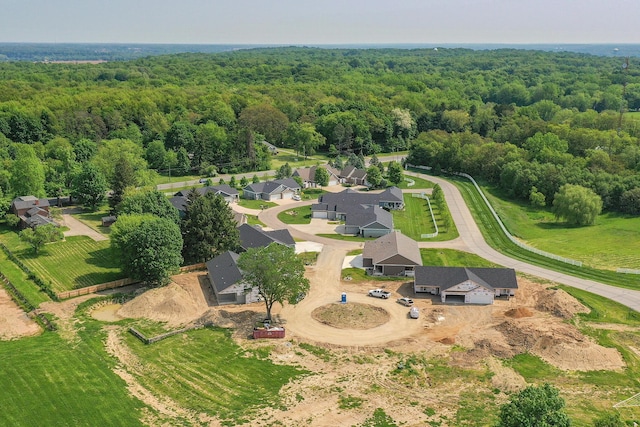 bird's eye view featuring a wooded view