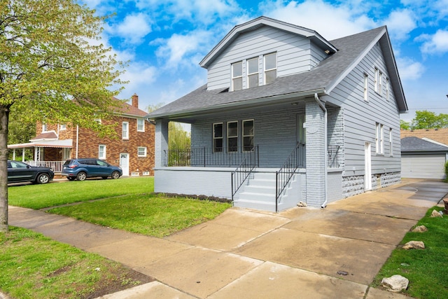 bungalow-style house with covered porch, brick siding, a front yard, and roof with shingles