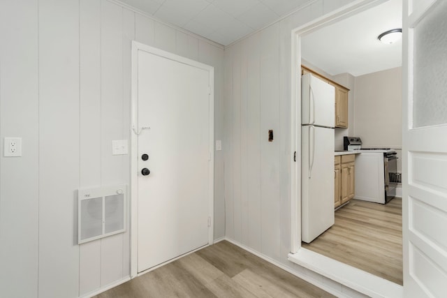 interior space featuring a decorative wall, light wood-style flooring, and visible vents