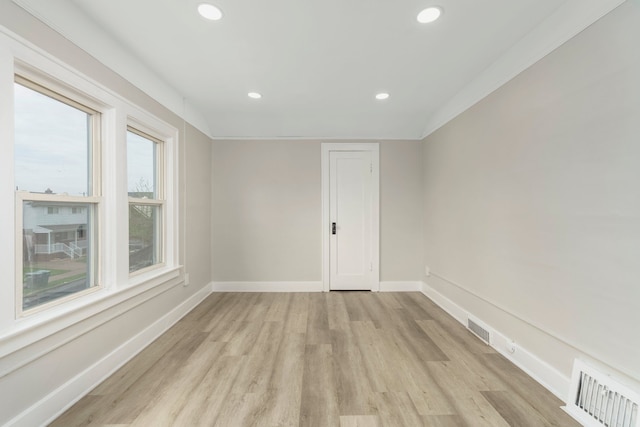 unfurnished room with recessed lighting, baseboards, visible vents, and light wood-style floors