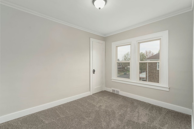 carpeted empty room with crown molding, baseboards, and visible vents