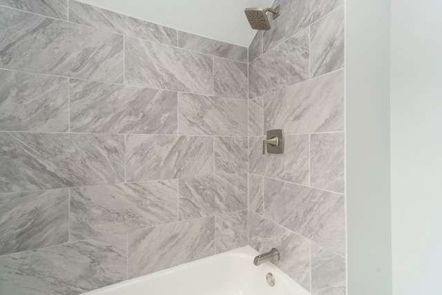 bathroom with washtub / shower combination