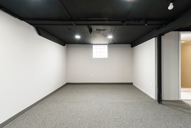 below grade area with baseboards and carpet