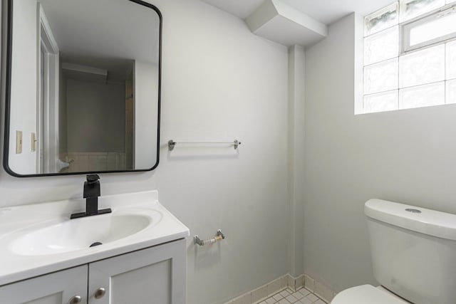 bathroom with vanity, baseboards, and toilet