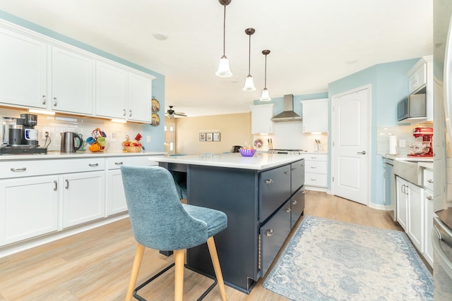 48320 Martz Rd, Michigan, MI 48111 - kitchen with wall chimney exhaust hood, backsplash, stainless steel microwave, and white cabinetry