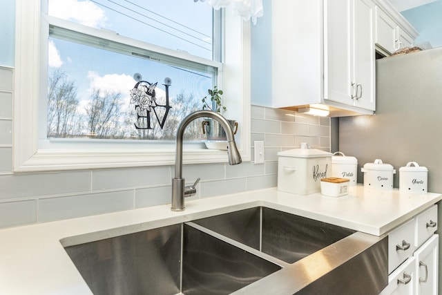 48320 Martz Rd, Michigan, MI 48111 - room details with decorative backsplash, a sink, white cabinets, and light countertops