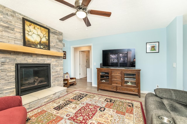 48320 Martz Rd, Michigan, MI 48111 - living room featuring a stone fireplace, wood finished floors, baseboards, and ceiling fan