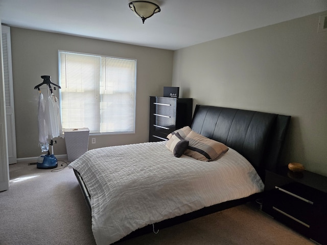 bedroom featuring multiple windows, visible vents, baseboards, and carpet