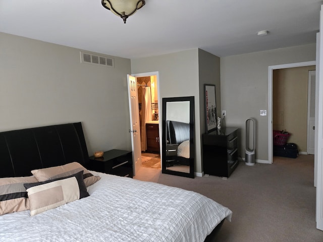 carpeted bedroom featuring baseboards and visible vents