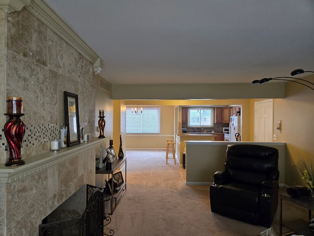 living area featuring a notable chandelier, visible vents, and light carpet