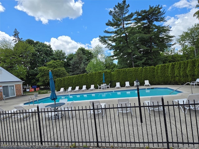 450 Billingsgate Unit C, Bloomfield Hills, MI 48301 - community pool featuring a patio and view of scattered trees