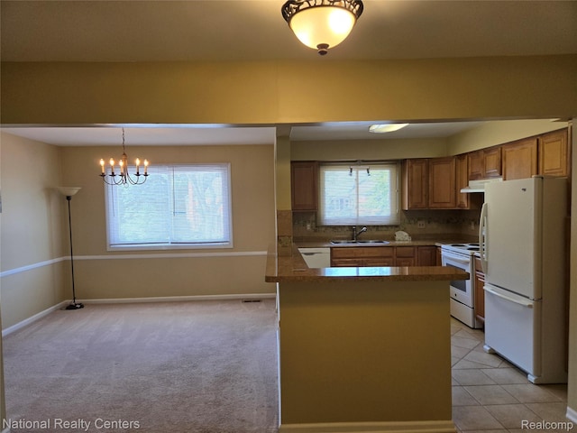 450 Billingsgate Unit C, Bloomfield Hills, MI 48301 - kitchen featuring white appliances, under cabinet range hood, a peninsula, brown cabinets, and decorative light fixtures