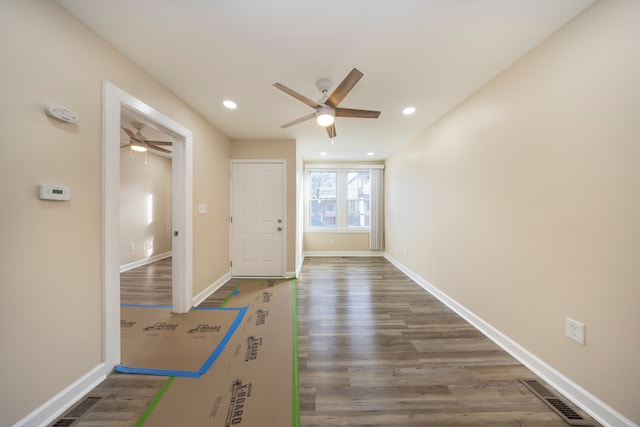 interior space featuring recessed lighting, wood finished floors, baseboards, visible vents, and a ceiling fan