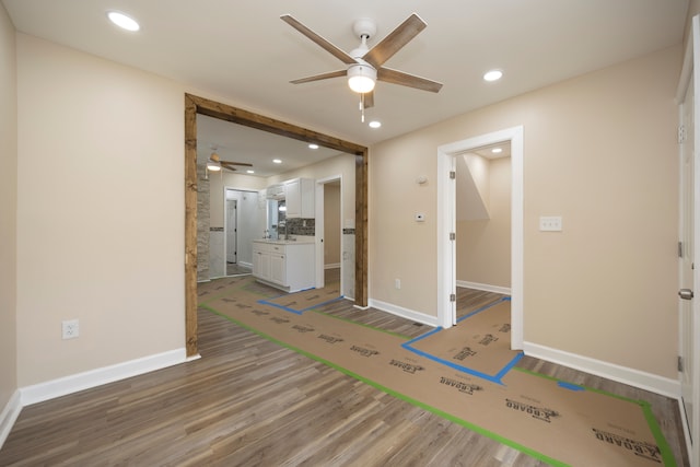 empty room featuring recessed lighting, ceiling fan, wood finished floors, and baseboards