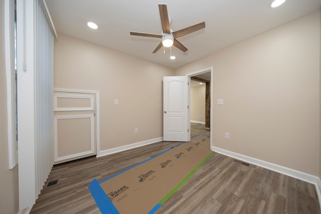 unfurnished bedroom with visible vents, baseboards, recessed lighting, wood finished floors, and a ceiling fan