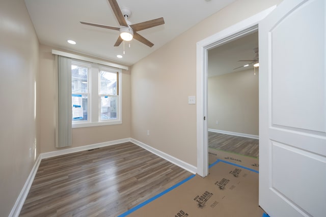 unfurnished bedroom with recessed lighting, a ceiling fan, wood finished floors, and baseboards