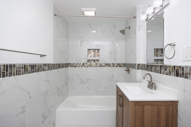 full bath featuring shower / bathing tub combination, vanity, backsplash, and tile walls