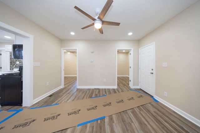 interior space with baseboards, recessed lighting, wood finished floors, and ceiling fan