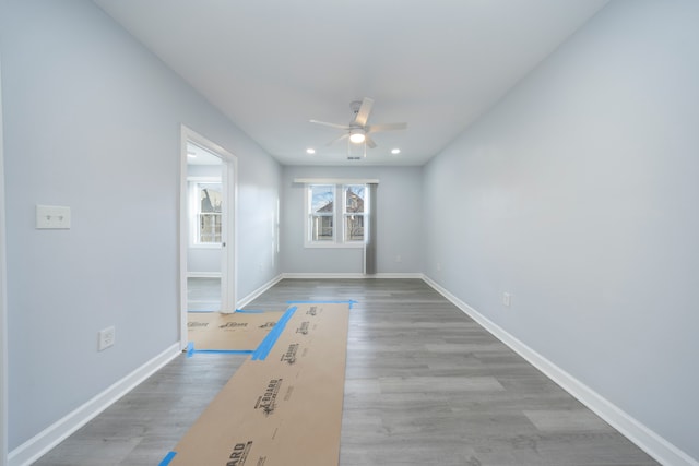 unfurnished room with baseboards, recessed lighting, wood finished floors, and a ceiling fan
