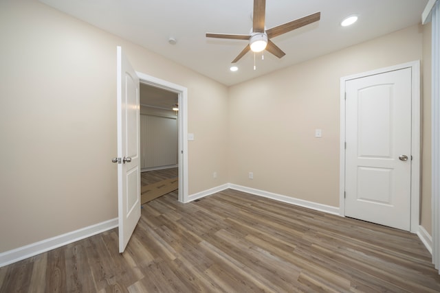 unfurnished bedroom featuring baseboards, recessed lighting, wood finished floors, and ceiling fan
