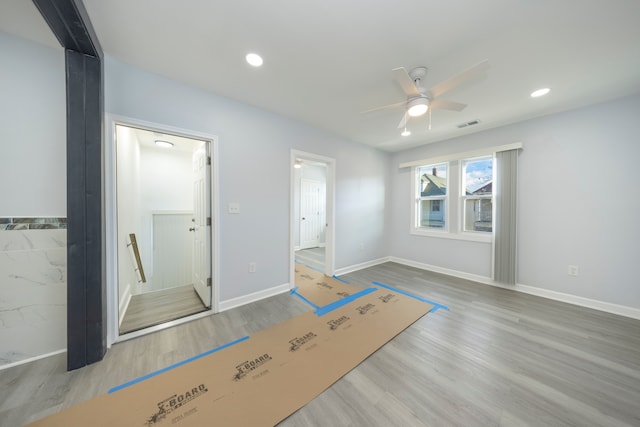 unfurnished bedroom featuring wood finished floors, recessed lighting, and baseboards