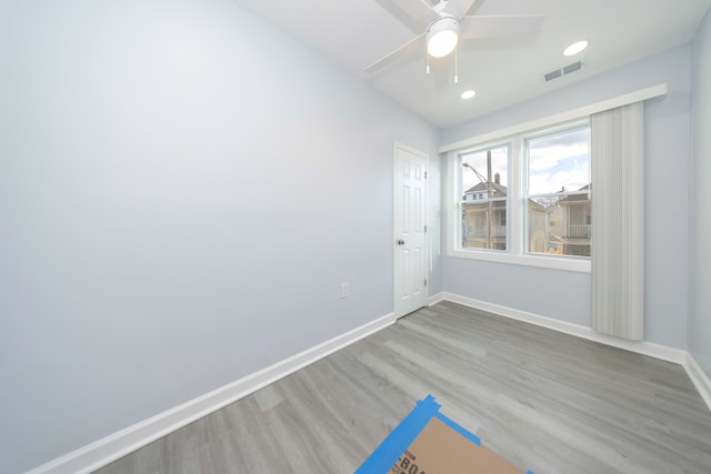 unfurnished room with recessed lighting, a ceiling fan, visible vents, baseboards, and wood finished floors