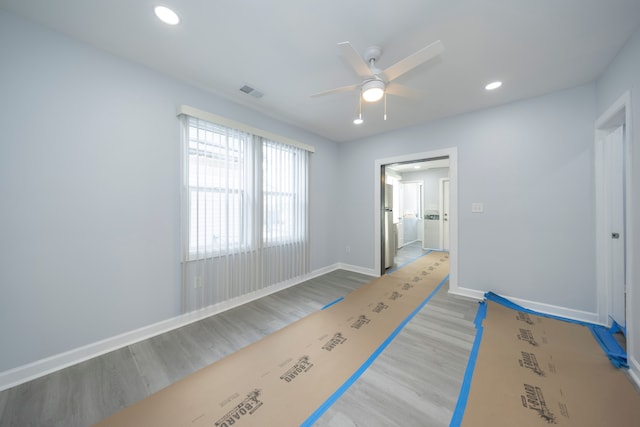 unfurnished bedroom with visible vents, baseboards, recessed lighting, wood finished floors, and a ceiling fan