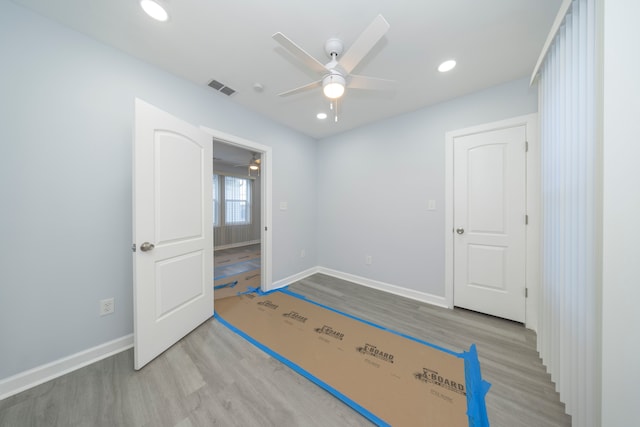 unfurnished room featuring visible vents, ceiling fan, wood finished floors, and baseboards