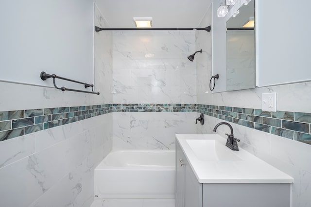 full bath featuring tile walls, shower / tub combination, and vanity