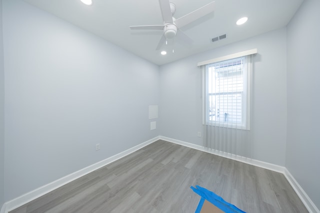 spare room with wood finished floors, ceiling fan, recessed lighting, and baseboards