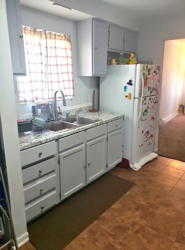 33 E Fairmount Ave, Pontiac, MI 48340 - kitchen featuring a sink, light countertops, and freestanding refrigerator