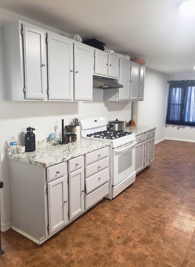 33 E Fairmount Ave, Pontiac, MI 48340 - kitchen with light stone countertops, baseboards, under cabinet range hood, and gas range gas stove