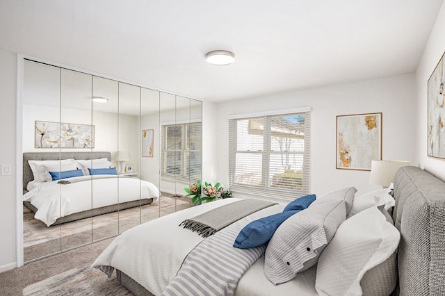 bedroom featuring baseboards and light colored carpet