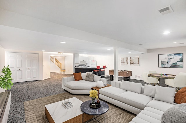 living room featuring carpet flooring, recessed lighting, stairs, and visible vents