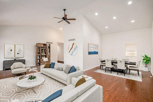 living room featuring high vaulted ceiling, ceiling fan, wood finished floors, and visible vents
