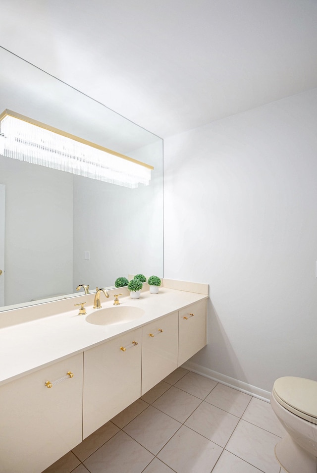 bathroom featuring toilet, tile patterned flooring, and vanity