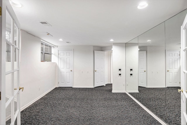 basement with dark carpet, recessed lighting, and baseboards