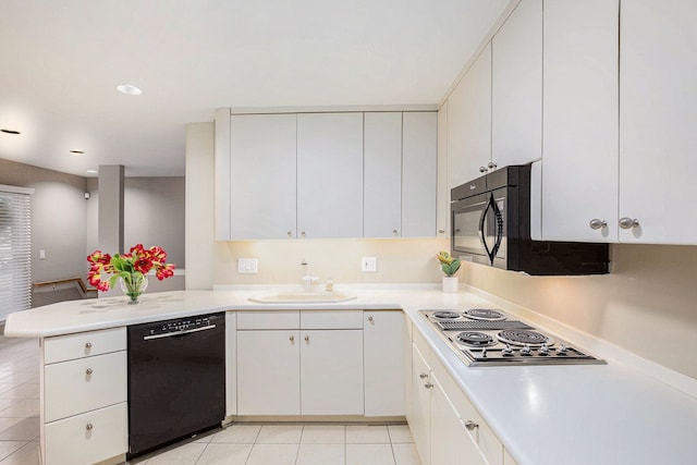 kitchen featuring black appliances, a sink, a peninsula, and light countertops