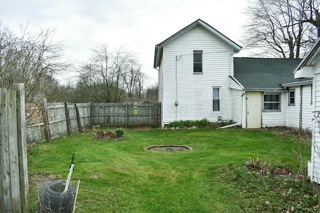 325 E Leroy St, Burlington, MI 49029 - back of house featuring fence, a lawn, and a shingled roof