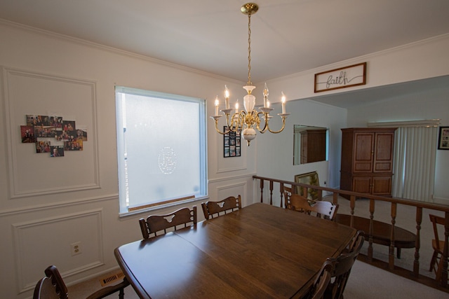 dining space featuring crown molding, visible vents, and a notable chandelier