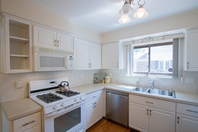 kitchen with a notable chandelier, a sink, white appliances, decorative backsplash, and glass insert cabinets