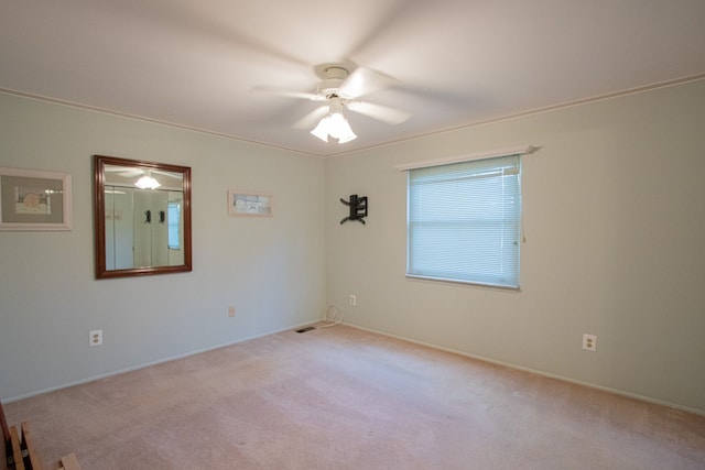carpeted empty room with baseboards and ceiling fan