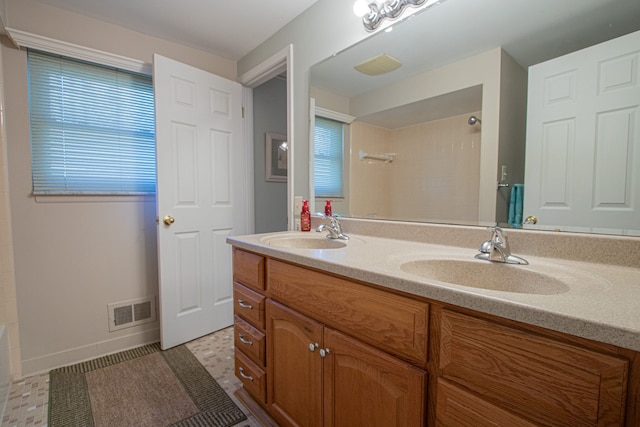 bathroom featuring a sink, walk in shower, and visible vents