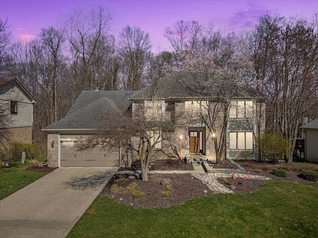 view of front facade with an attached garage, concrete driveway, and a lawn