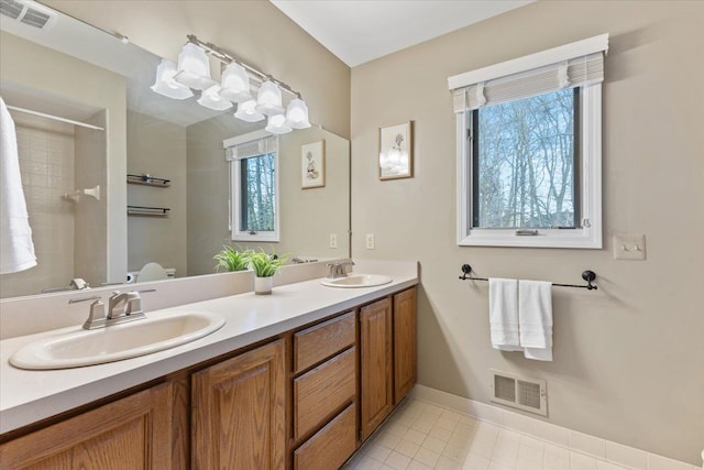 bathroom featuring visible vents, a wealth of natural light, and a sink