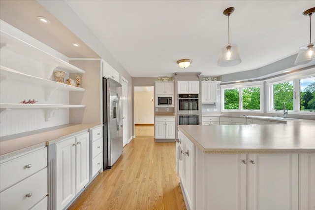 2485 Kimberly Fair St, Rochester Hills, MI 48309 - kitchen with appliances with stainless steel finishes, light countertops, white cabinets, light wood-style floors, and recessed lighting